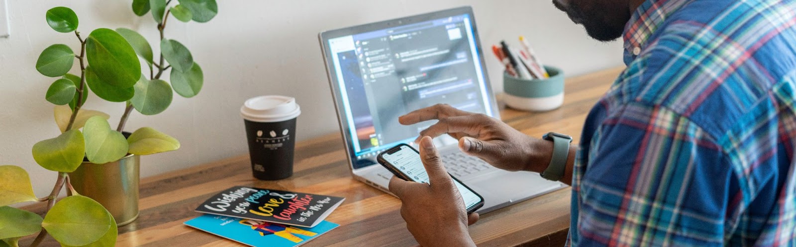 a man holding a phone while working