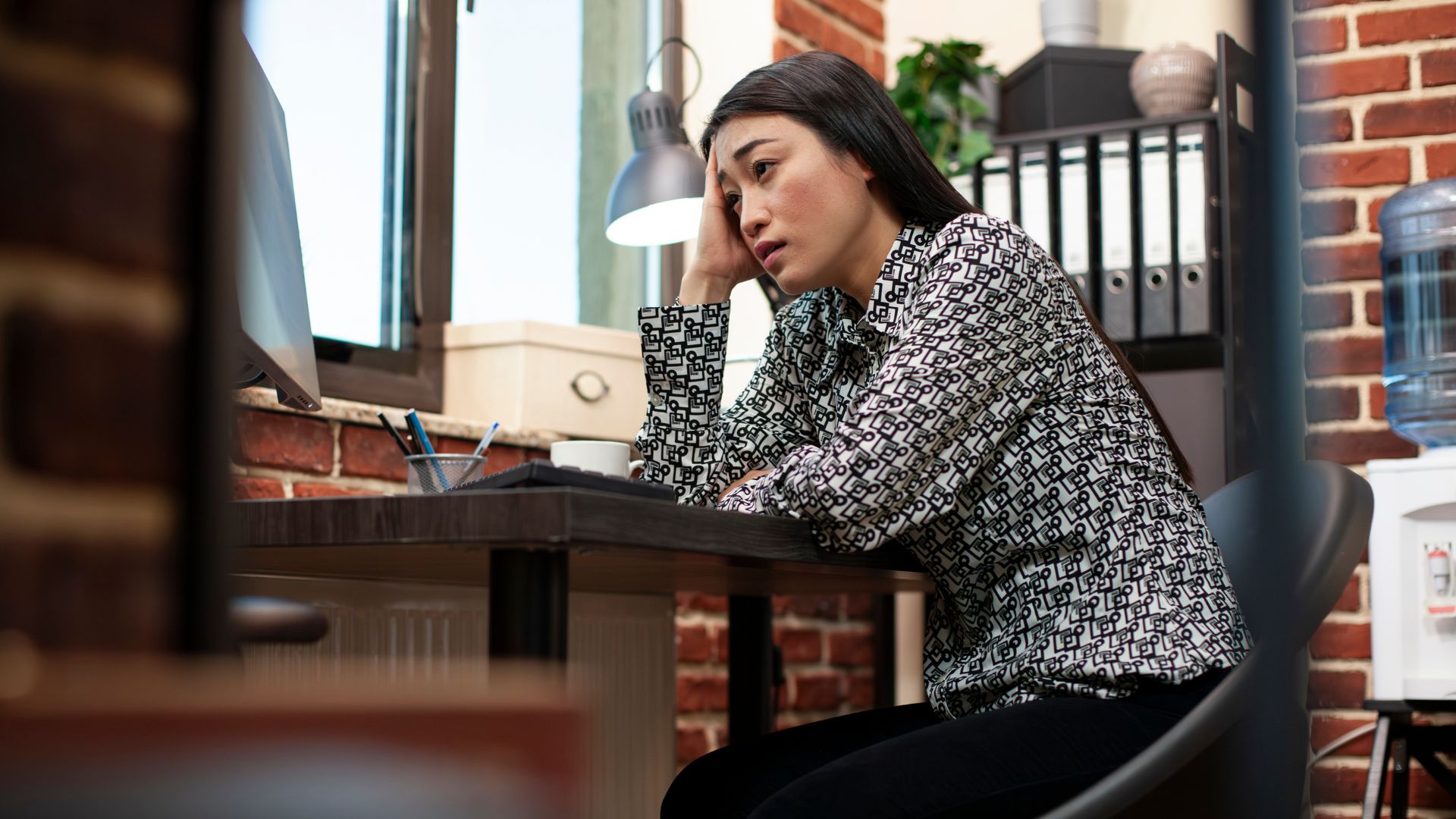 Stressed employee leaning on a table